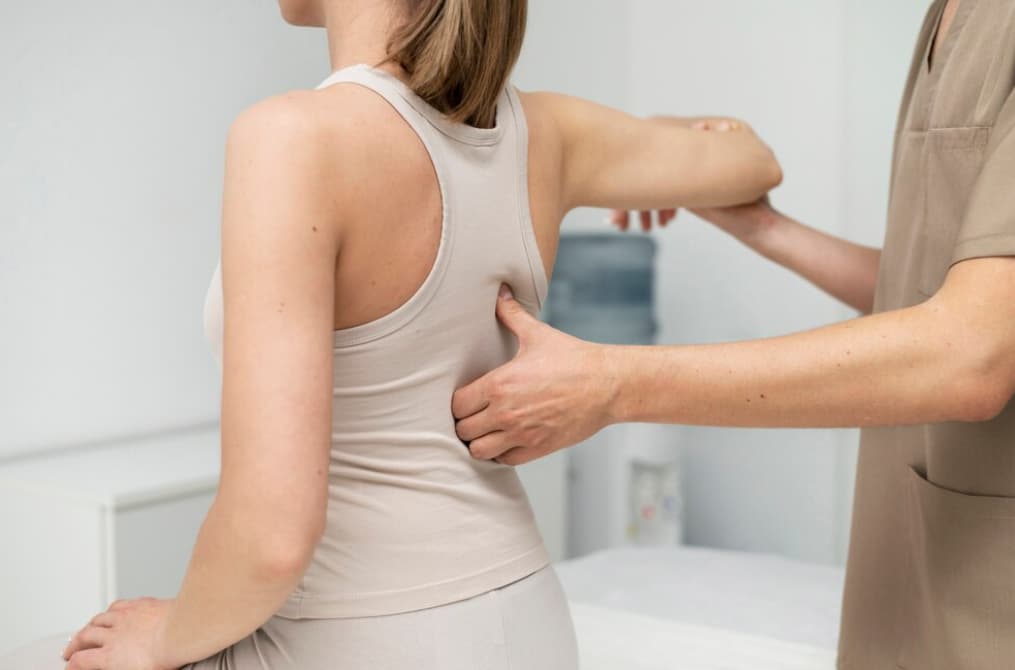 A patient is being physically examined by a therapist